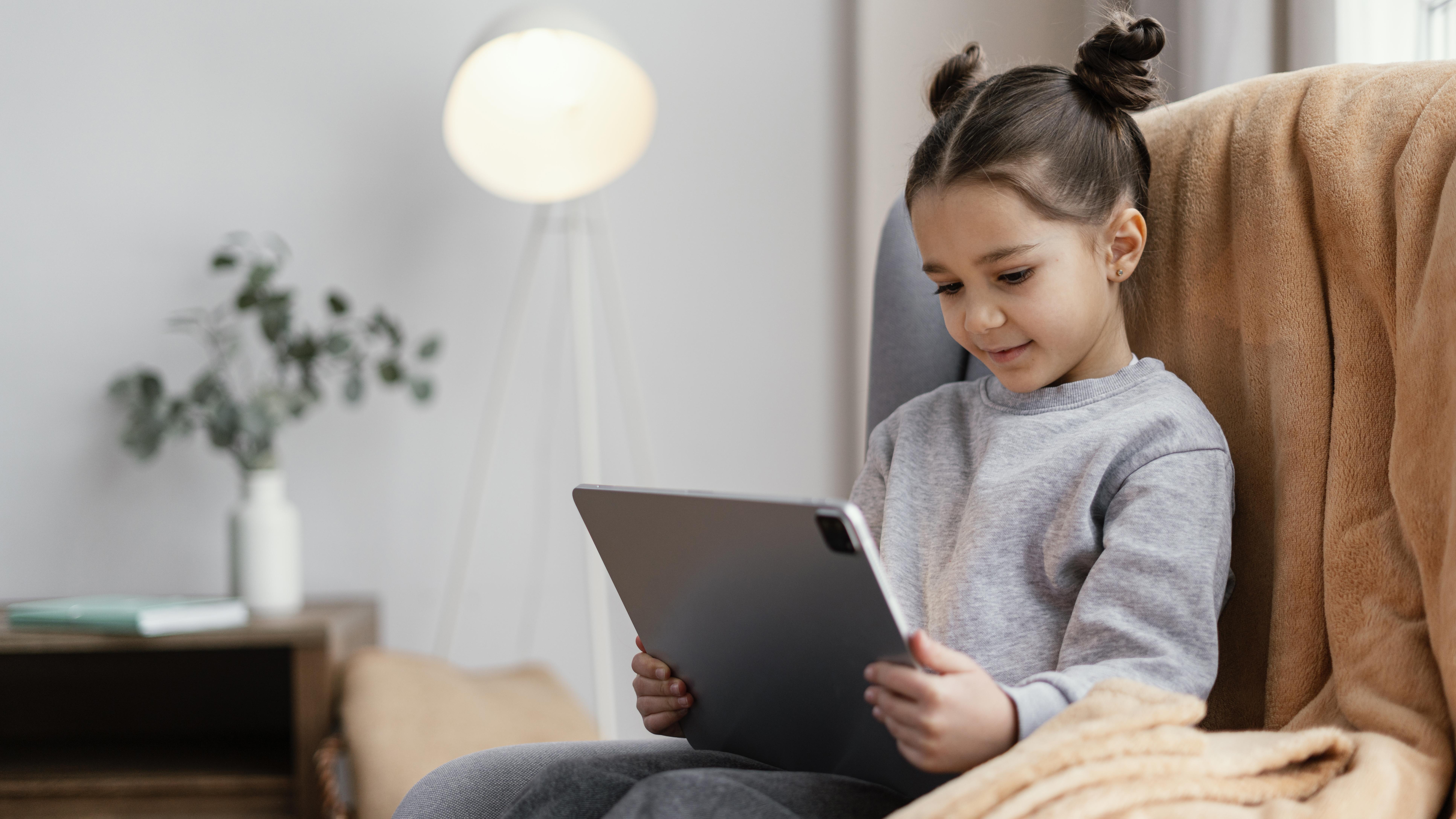 little-girl-couch-using-tablet.jpg